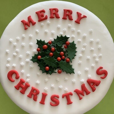 Red merry Christmas letters with holly and berries sugar paste cake decorations