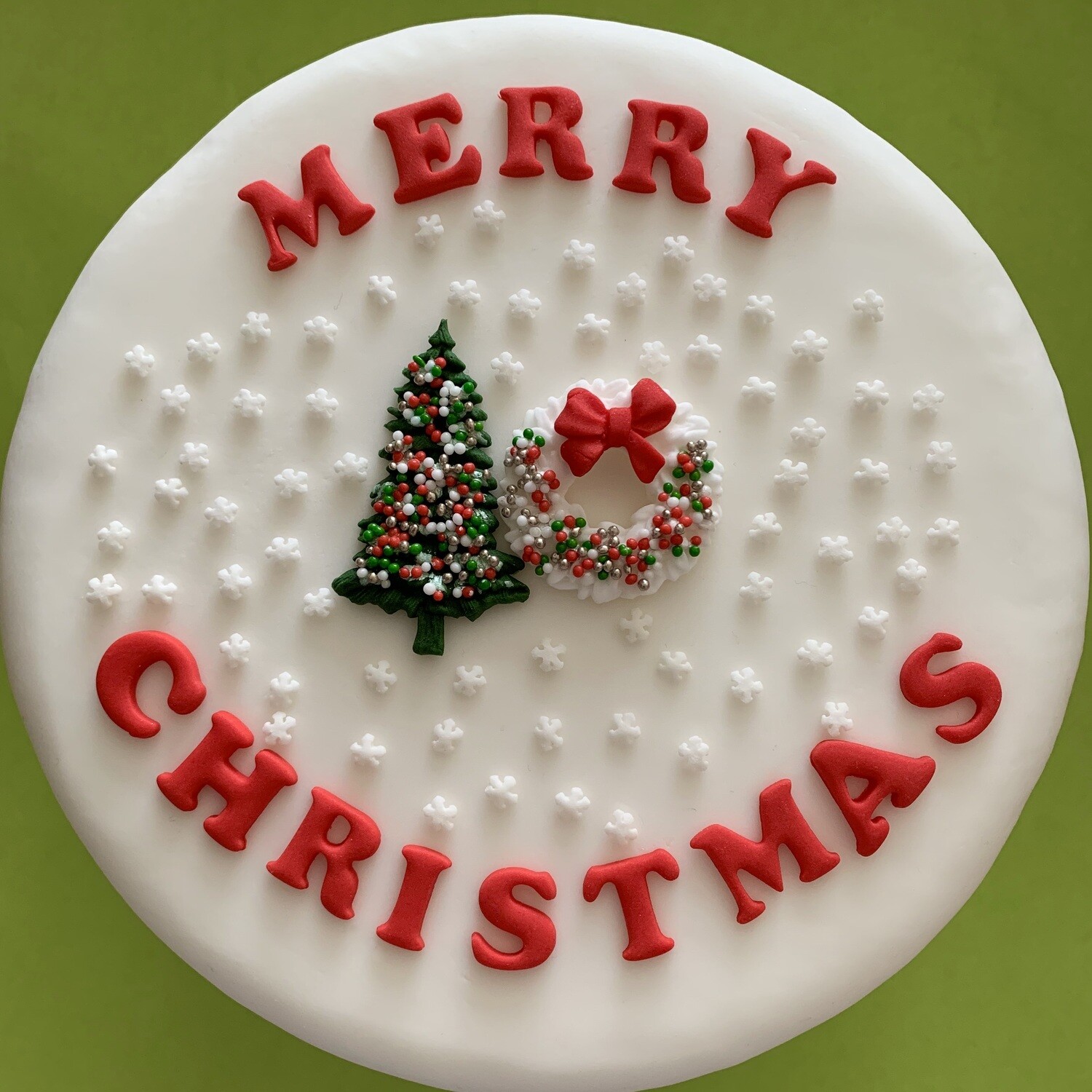 Red Merry Christmas letters with green tree and white wreath