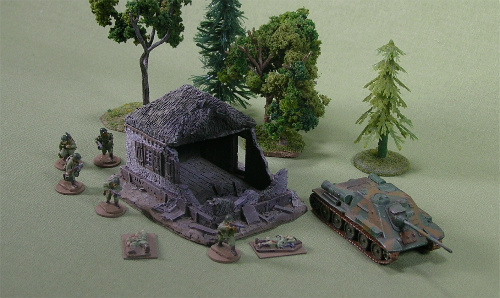 Battle-damaged small cottage, stucco walls, thatched roof