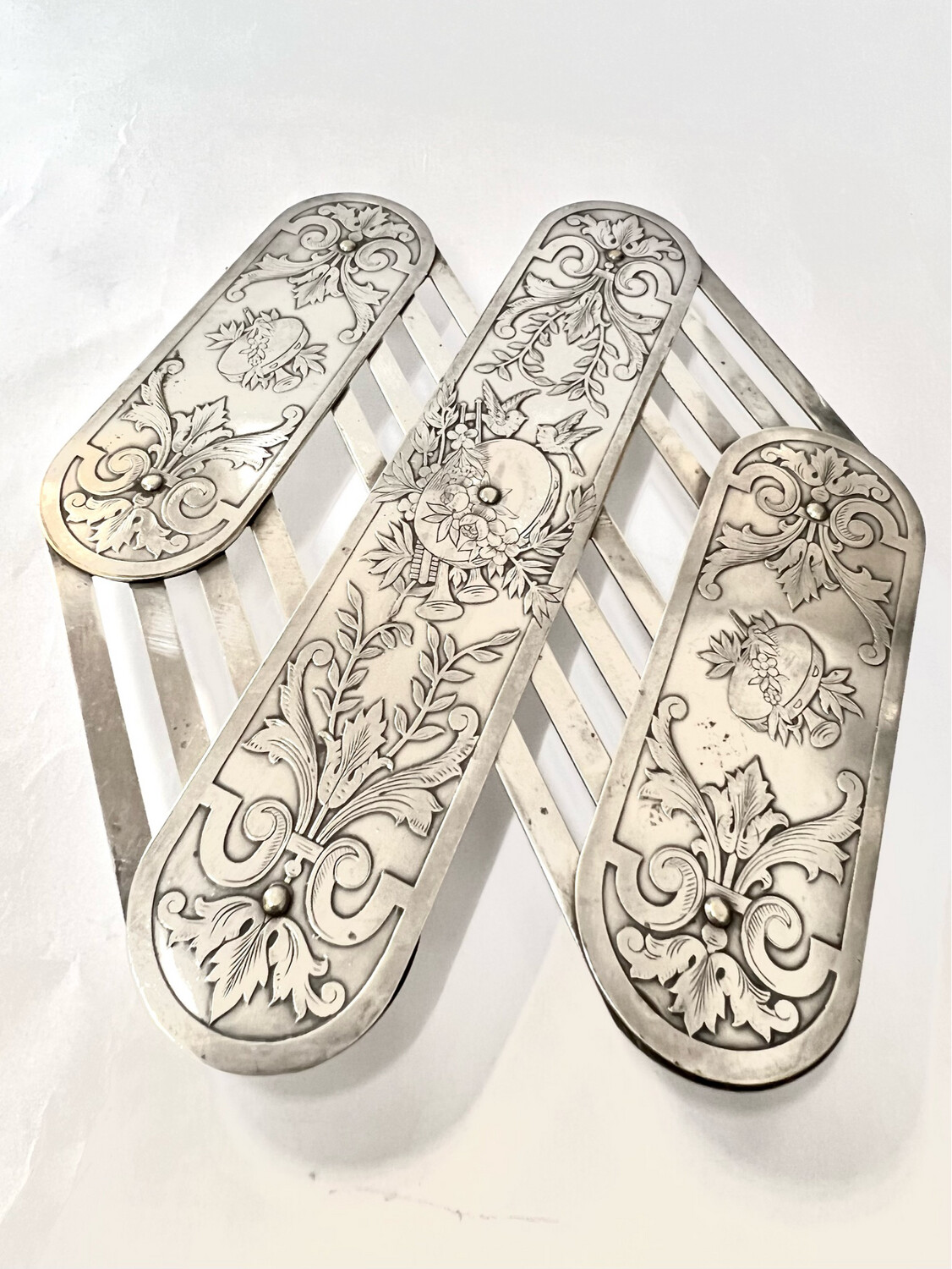 extendable art nouveau silverplated coaster hot plate stand decorated with flowers birds and musical instruments patended