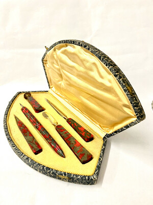 Writing set 5 pieces red colorful marbled Bakelite pencil, feather letter opener seal in original case around 1920