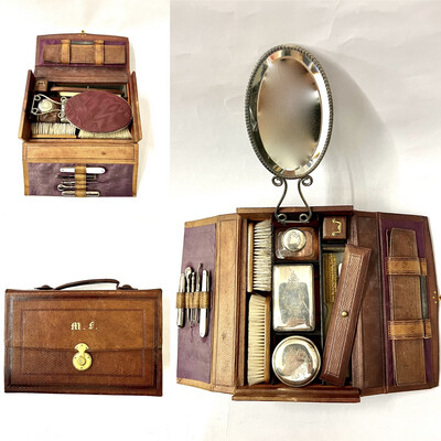 Antique leather cosmetic vanity beauty case fully equipped for travel around 1870 in leather with mirror, brushes, inkwell, lidded boxes, pocket knives, tweezers, button hooks, needle box,nail file  etc