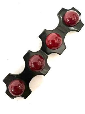 Belt buckle, 2 parts, made of black Bakelite with red balls mounted on metal around 1920