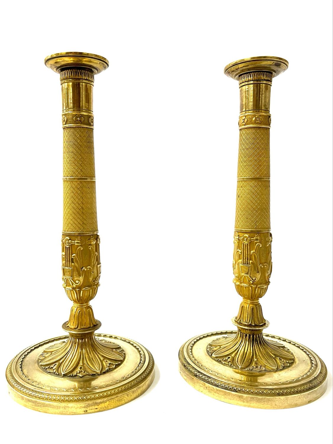 A pair of fire-gilt bronze candlesticks, circa 1810, Empire France The gilding is not perfect 