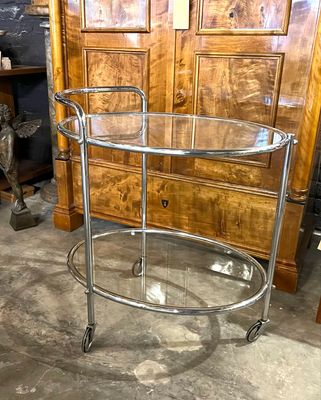 An original English tea trolley, bar trolley, serving trolley was made around 1930 in chrome and glass with clean lines and simple elegance, this bar trolley has three wheels .