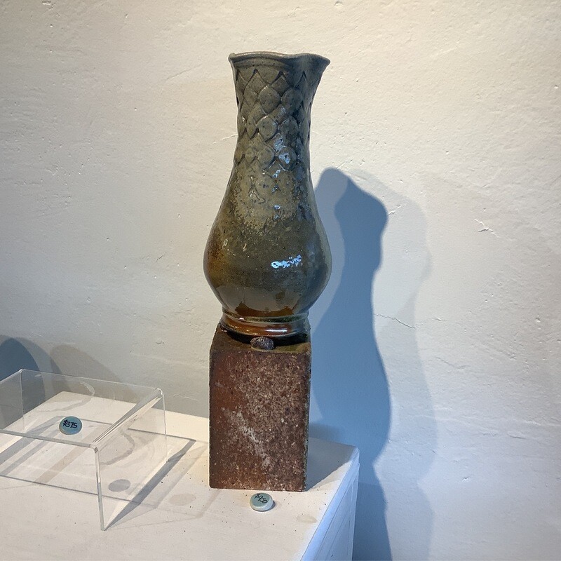 Wood fire vase on brick