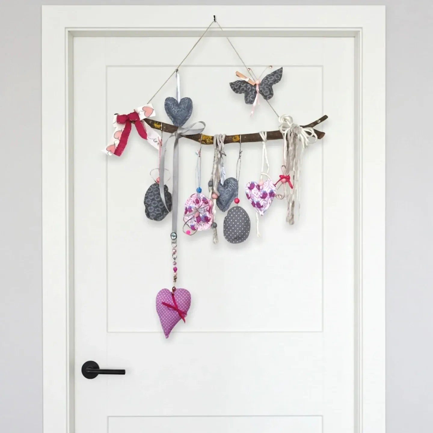 dekorierte zweige österliches wandgesteck osterei drahthase