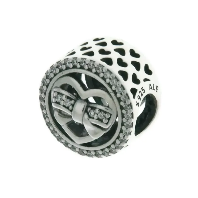 Heart charm in SS with clear CZ in bow detail and cut-out heart pattern
