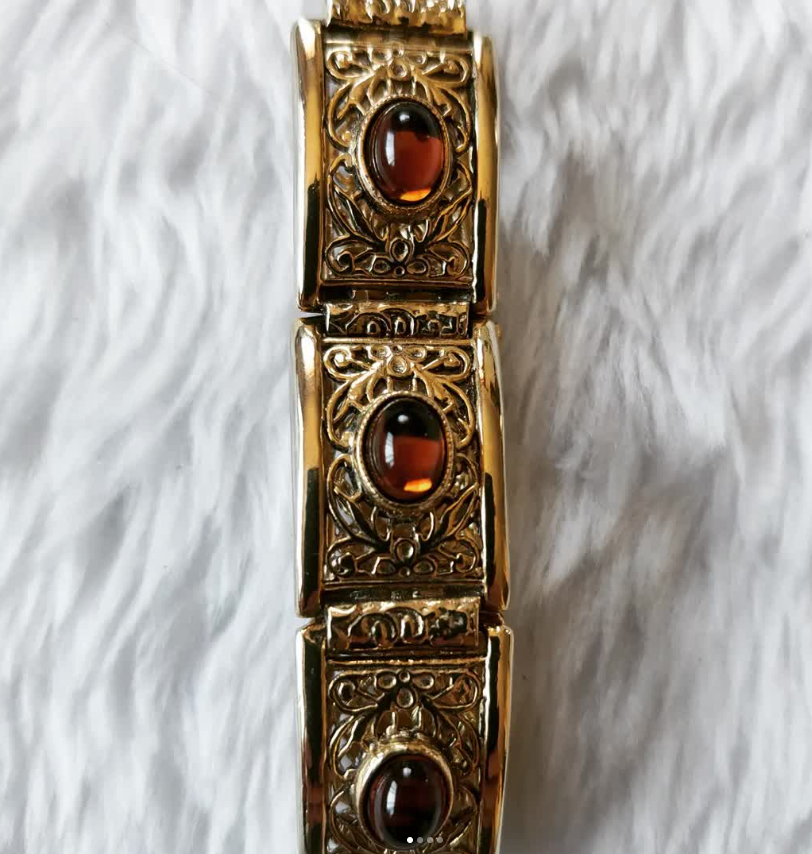 Gold tone bracelet with amber glass stones