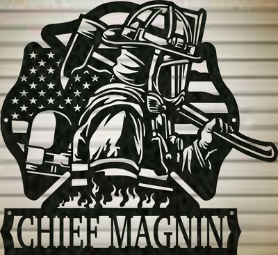 Close-up of a black firefighter metal sign with American flag, Maltese cross, and personalized CHIEF MAGNIN lettering.