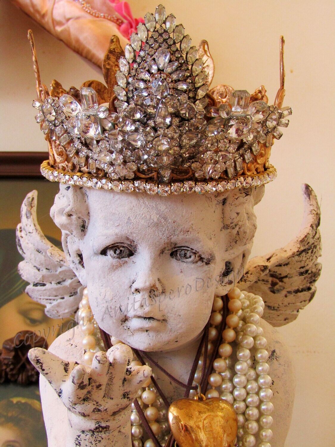 Cherub statue with handmade rhinestone crown by Anita Spero