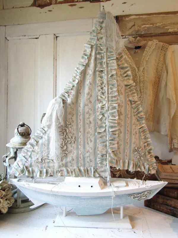 Shabby beach wooden sailboat with vintage ticking