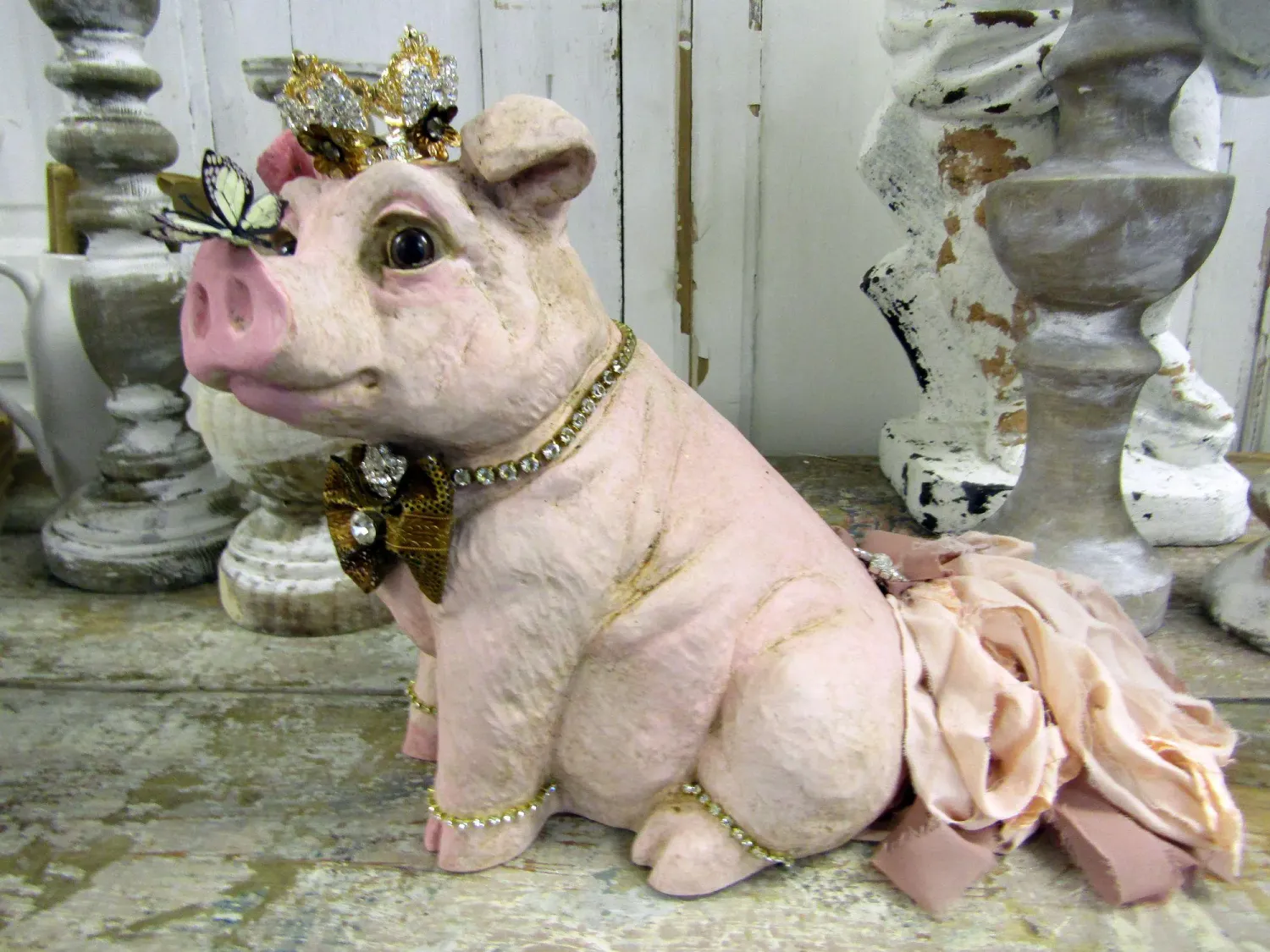 Pink embellished pig statue with rhinestone crown
