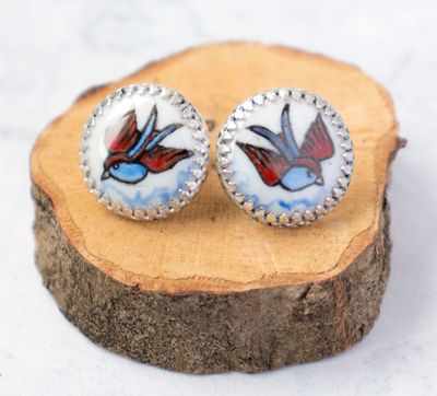 Hand made and enamelled swallow earrings in blue and red - inspired by old sailors&#39; tattoos.