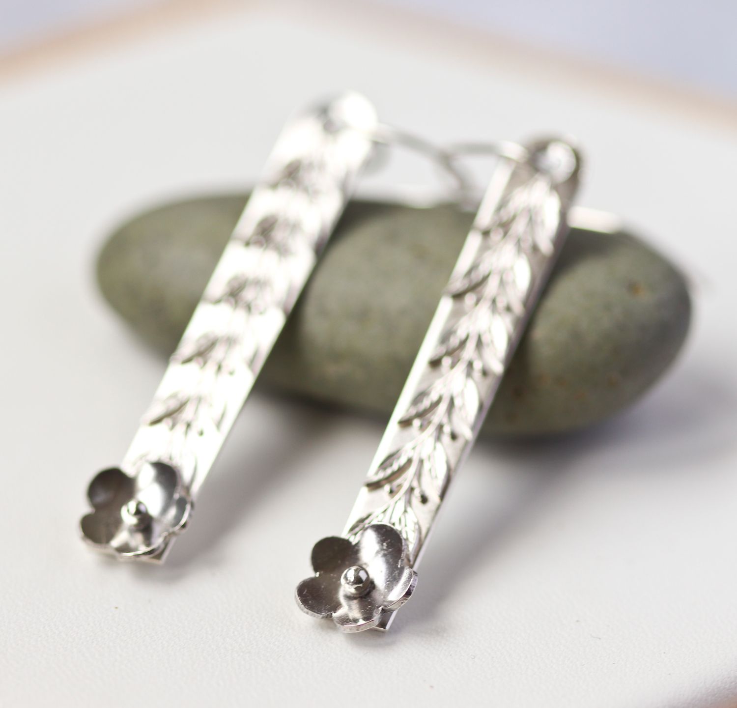 Sterling silver daisy drop earrings.