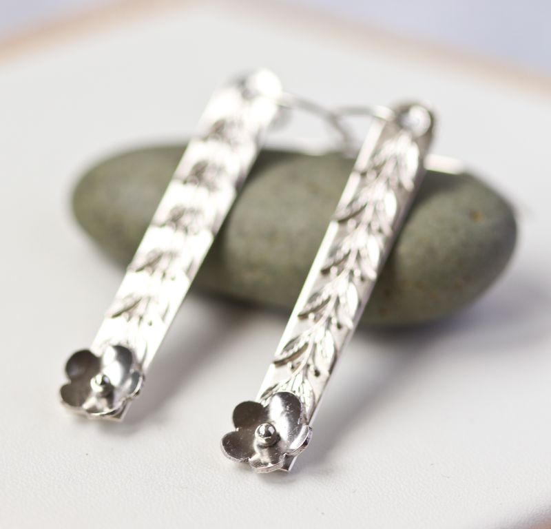 Sterling silver daisy drop earrings.