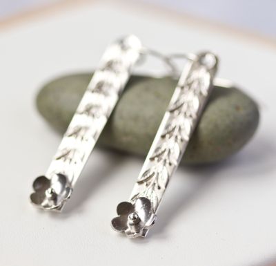 Sterling silver daisy drop earrings.