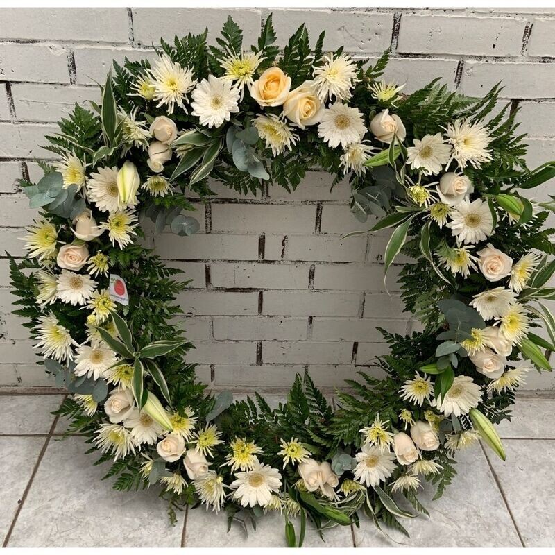 Corona grande de gerberas y rosas en blanco