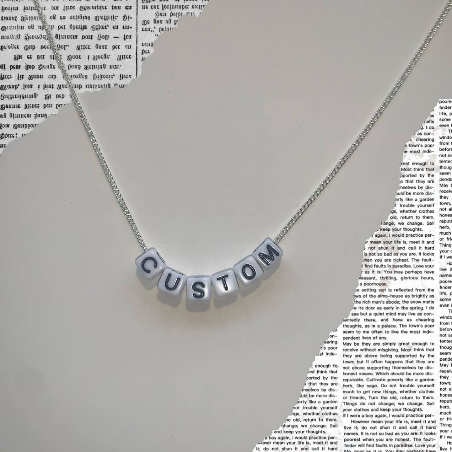 White bead with black lettering
