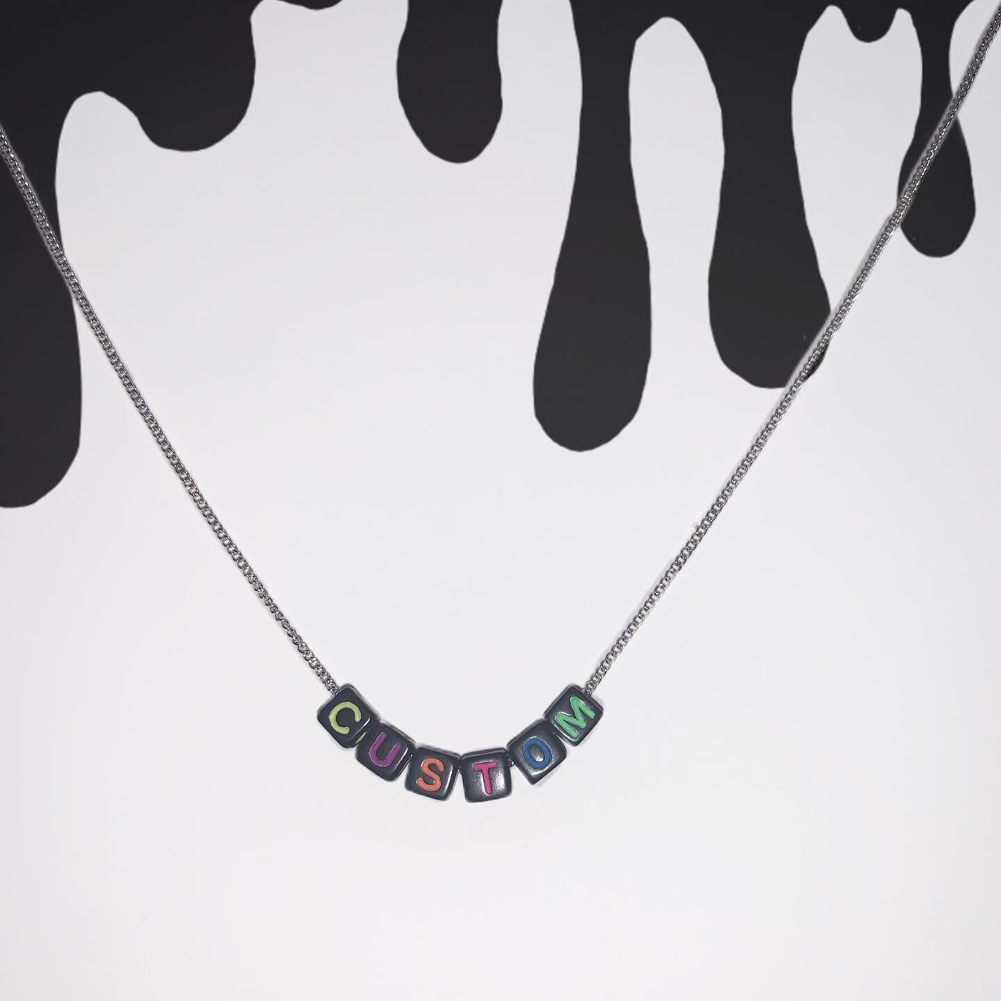 Black bead with multicolour lettering