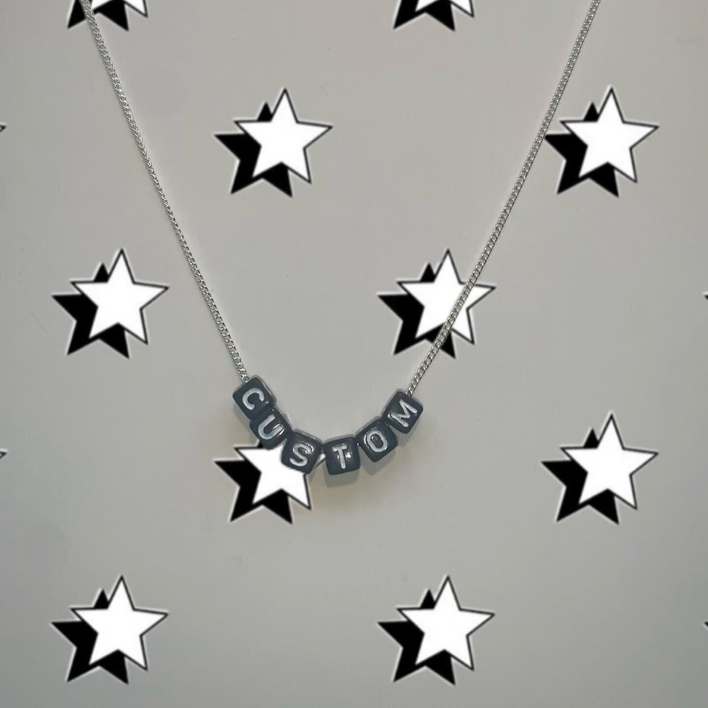 Black bead with white lettering