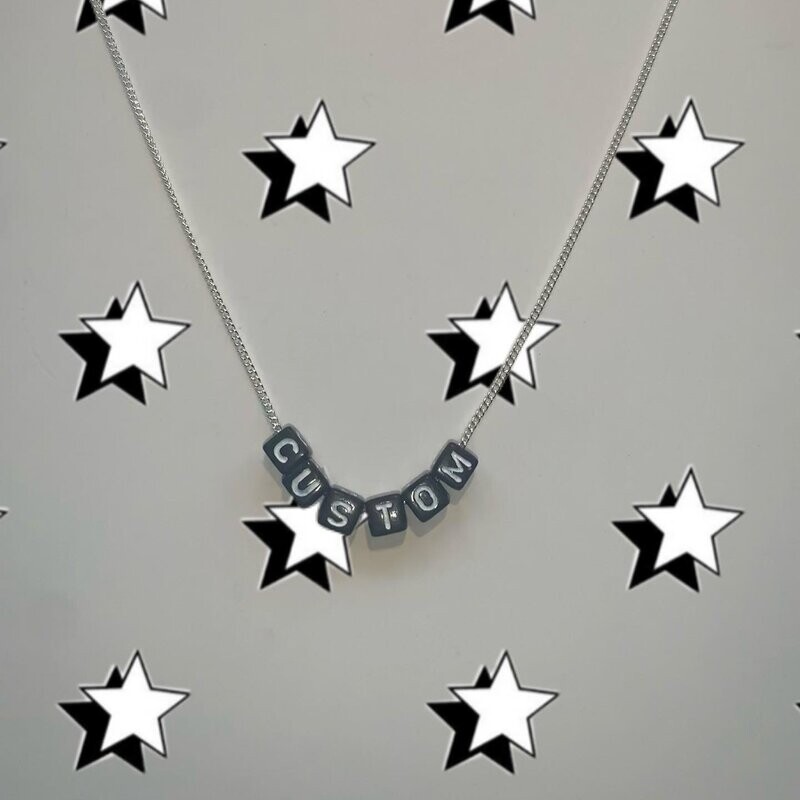 Black bead with white lettering