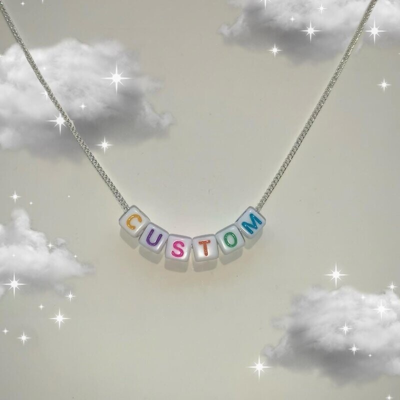 White bead with coloured lettering