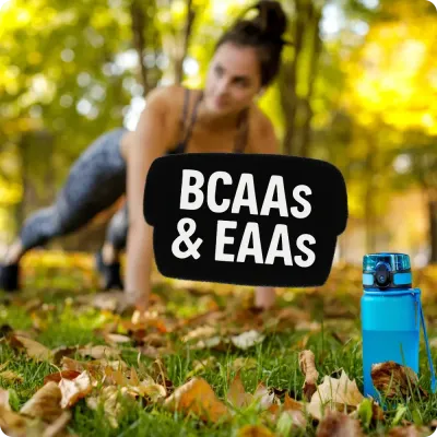 Woman training outdoors with water bottle and BCAAs &amp; EAAs text, featuring amino acid recovery supplements.