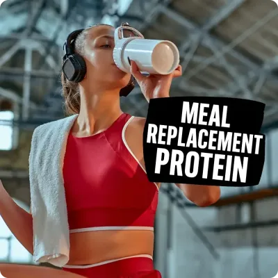 Woman drinking shake in gym with Meal Replacement Protein text, highlighting Natural Body’s selection of meal replacement.