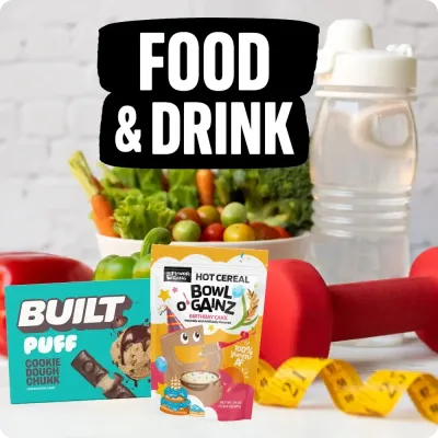 Built protein bar and Bowl O’ Gainz cereal with fresh produce and shaker, highlighting healthy food and drinks.