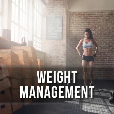 Woman standing in a gym near plyo boxes representing weight management products.