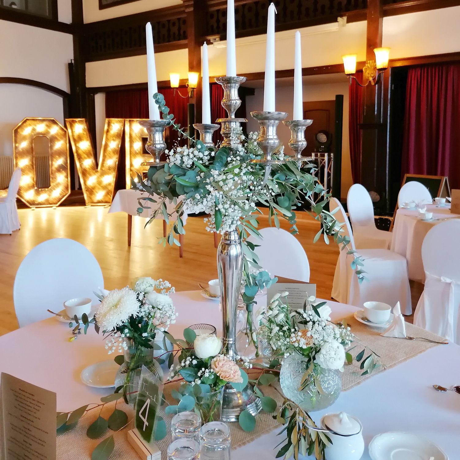 Leuchter mit Eukalyptus und Blütengläser