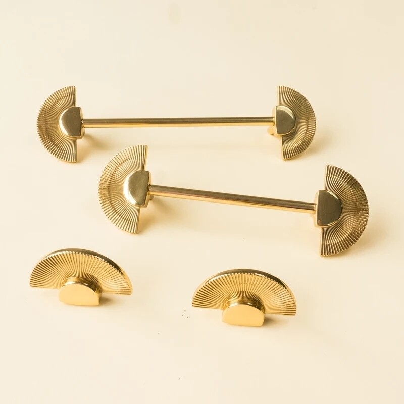 A pair of gold Art deco Sun Ray cabinet handles 
