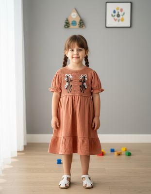 Adorable terracotta-colored girls’ frock