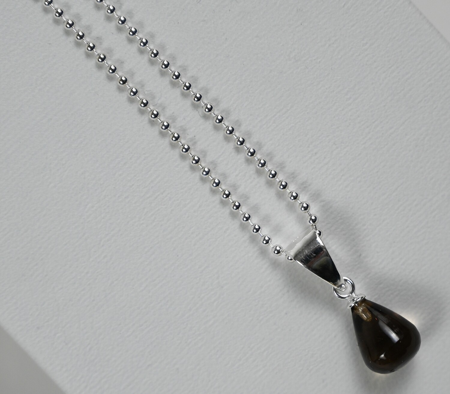 DROPS necklace, made of 925 sterling silver bead chain and pendant of brown moonstone. Handmade by Helle Hennie
