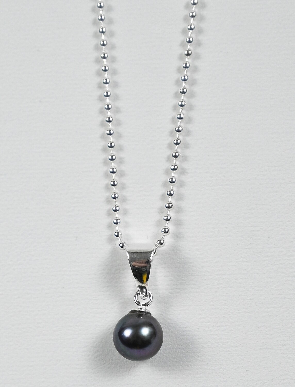 Joyful necklace made of sterling silver 925 bead chain and pendant of black fresh water pearl 7 mm. Handmade by Helle Hennie