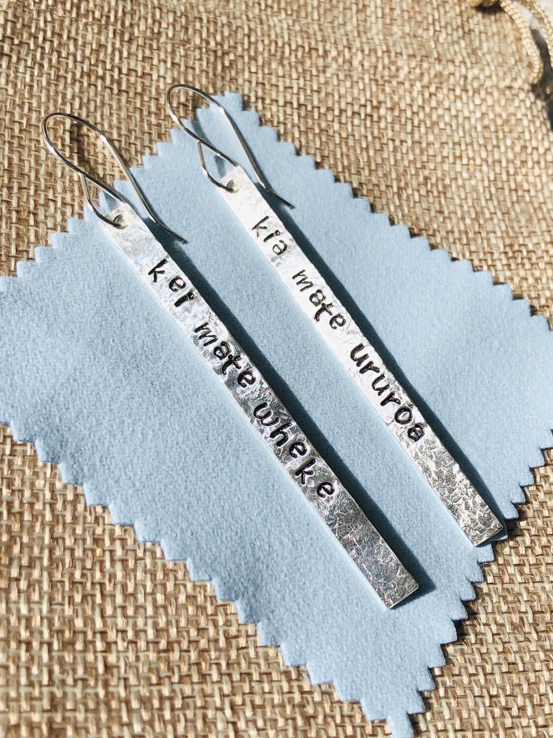 Earrings: whakataukī - kia mate ururoa, kei mate wheke ... fight like a shark, not like an octopus