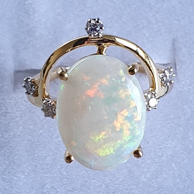 R12  Opal & Diamond Dress Ring Featuring an Oval Solid White Opal Supported by 5 Brilliant Cut Diamonds Claw Set in 9ct Yellow Gold