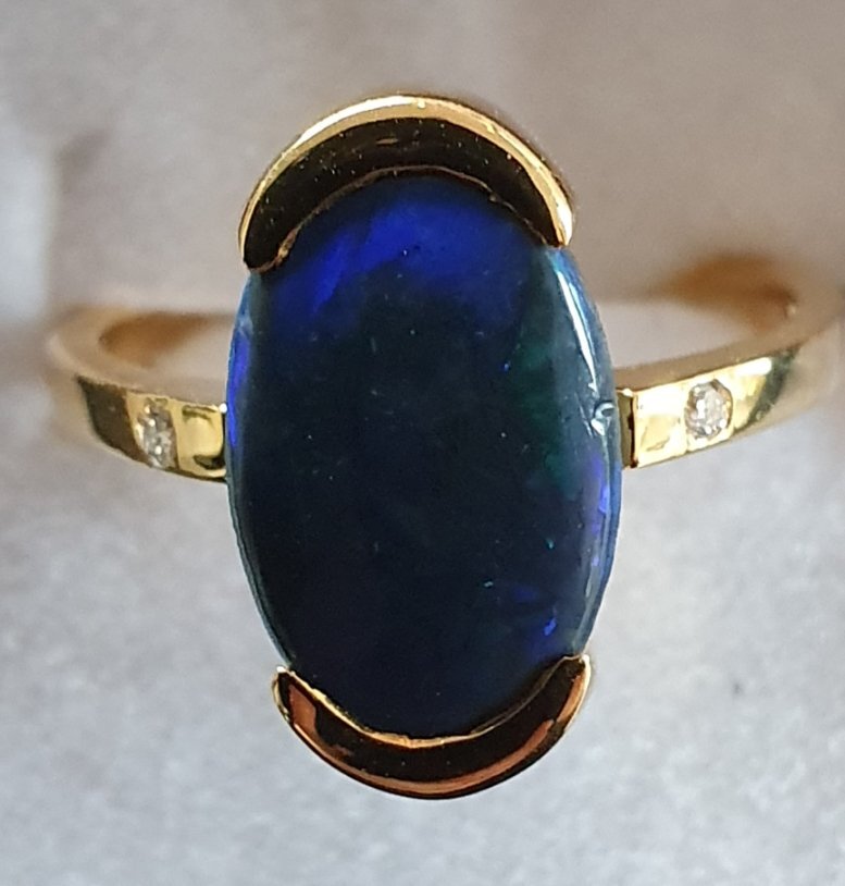 R18 Black Opal & Diamond Ring, Featuring Lightning Ridge Black Solid Opal Cabochon, Set in 9ct Gold With Diamond Shoulders. Predominant Purple and Green Flashing Colours