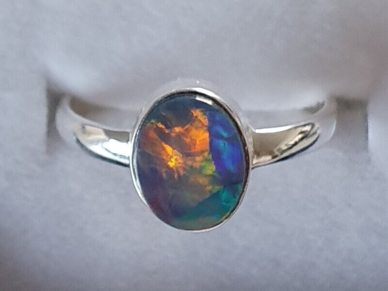 R25  Sterling Silver Set Solid Black Opal Ring, 8 X 10mm Across Face With Red/Orange Rolling Flash Over Green & Blue Colours