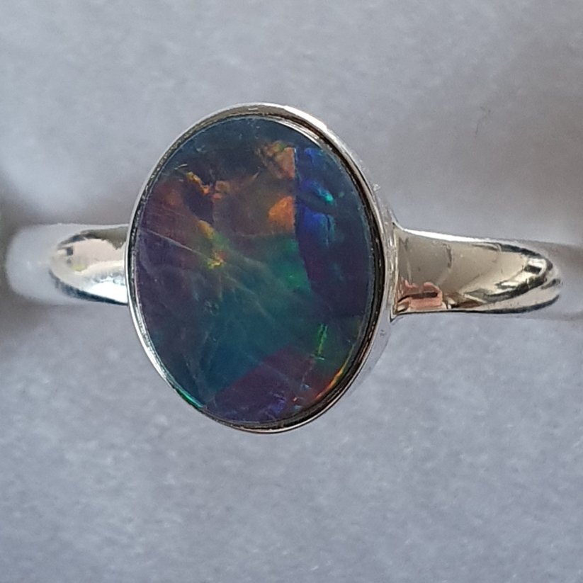 R25  Sterling Silver Set Solid Black Opal Ring, 8 X 10mm Across Face With Red/Orange Rolling Flash Over Green & Blue Colours
