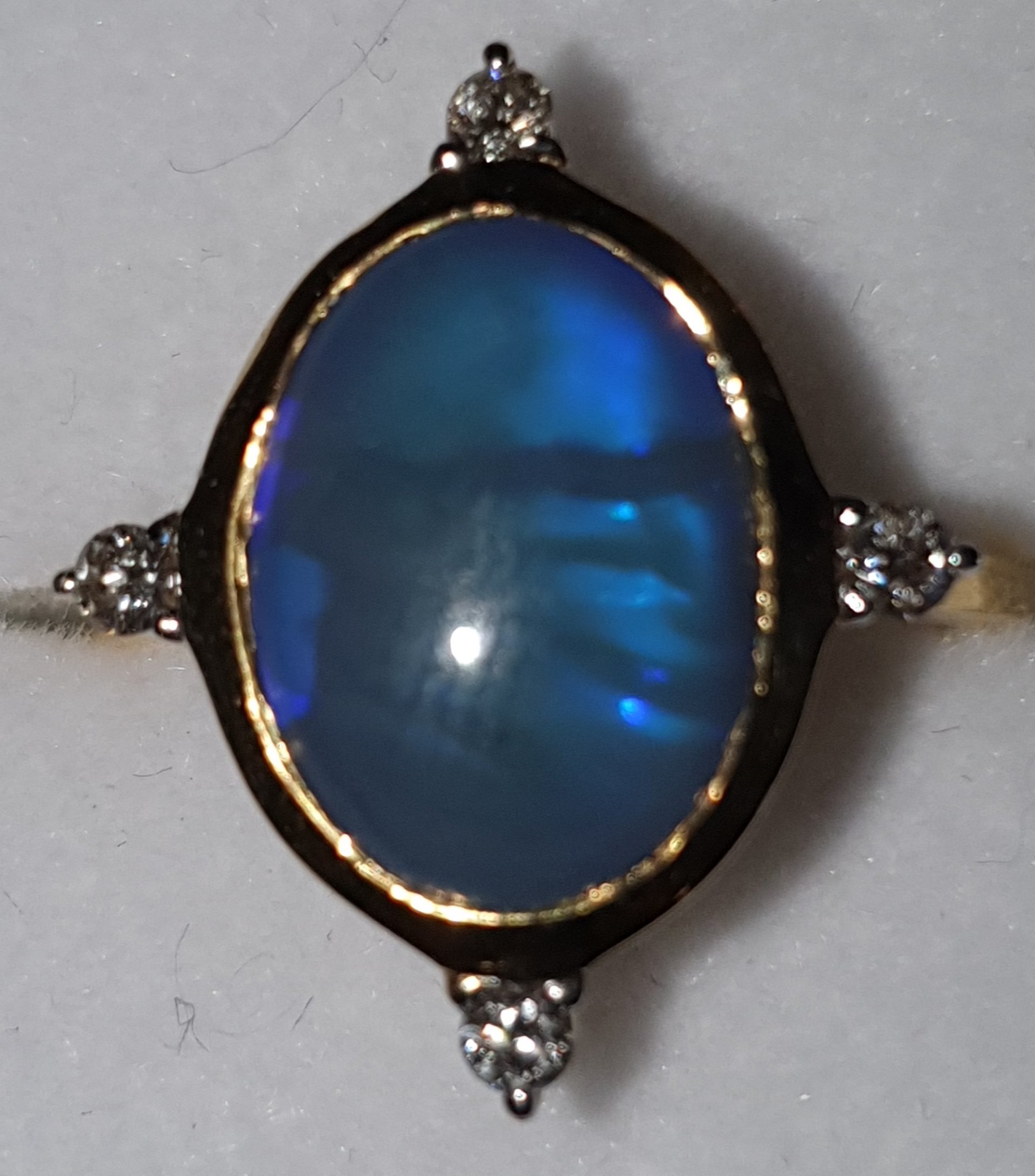 R14 Opal & Diamond Dress Ring, Featuring Oval Cut Solid Black Opal Cabochon Set With 4 Brilliant Cut Diamonds Claw Set on 9ct Yellow Gold