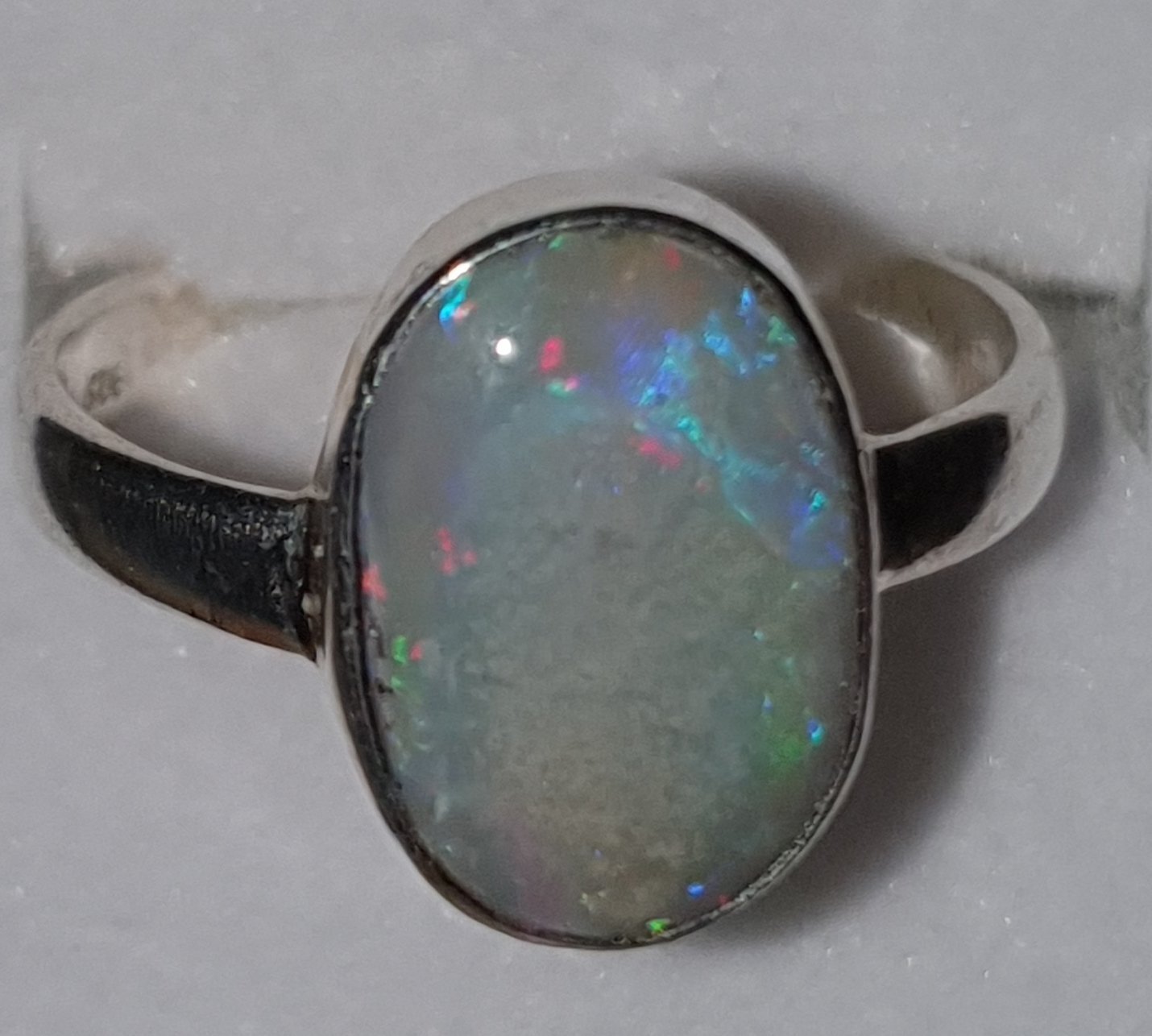 R24  Sterling Silver Set Solid Grey Base Opal, 10 X 15mm Across Face With Red, Orange, Yellow, Green, Blue & Purple Flash