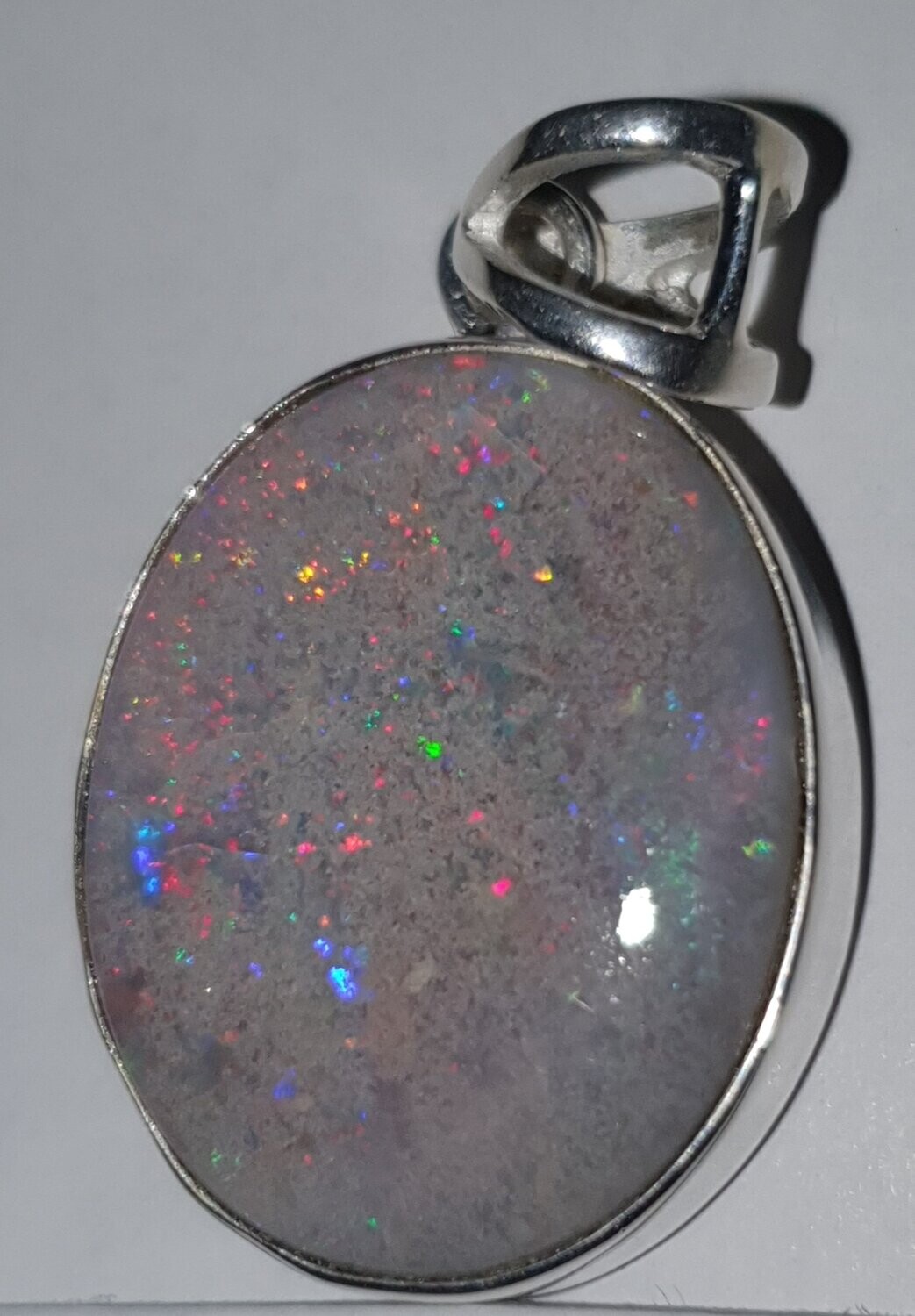 P30 Grey Base Solid Opal Pendant Mounted in Sterling Silver, 20 X 25mm Displaying Rolling Red Flash With Fairy Lights of Red, Purple & Green