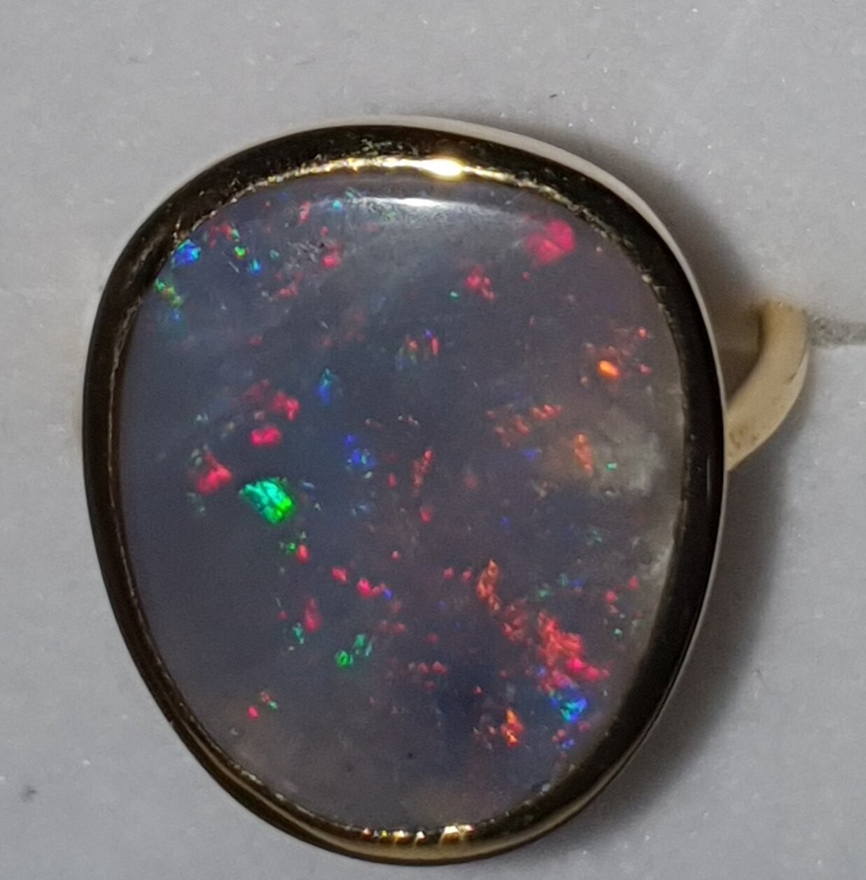 R19   Lightning Ridge Semi Black Opal Dress Ring Set in 9ct Gold, Displaying Predominantly Reds, Greens, Blues in a Dark Base