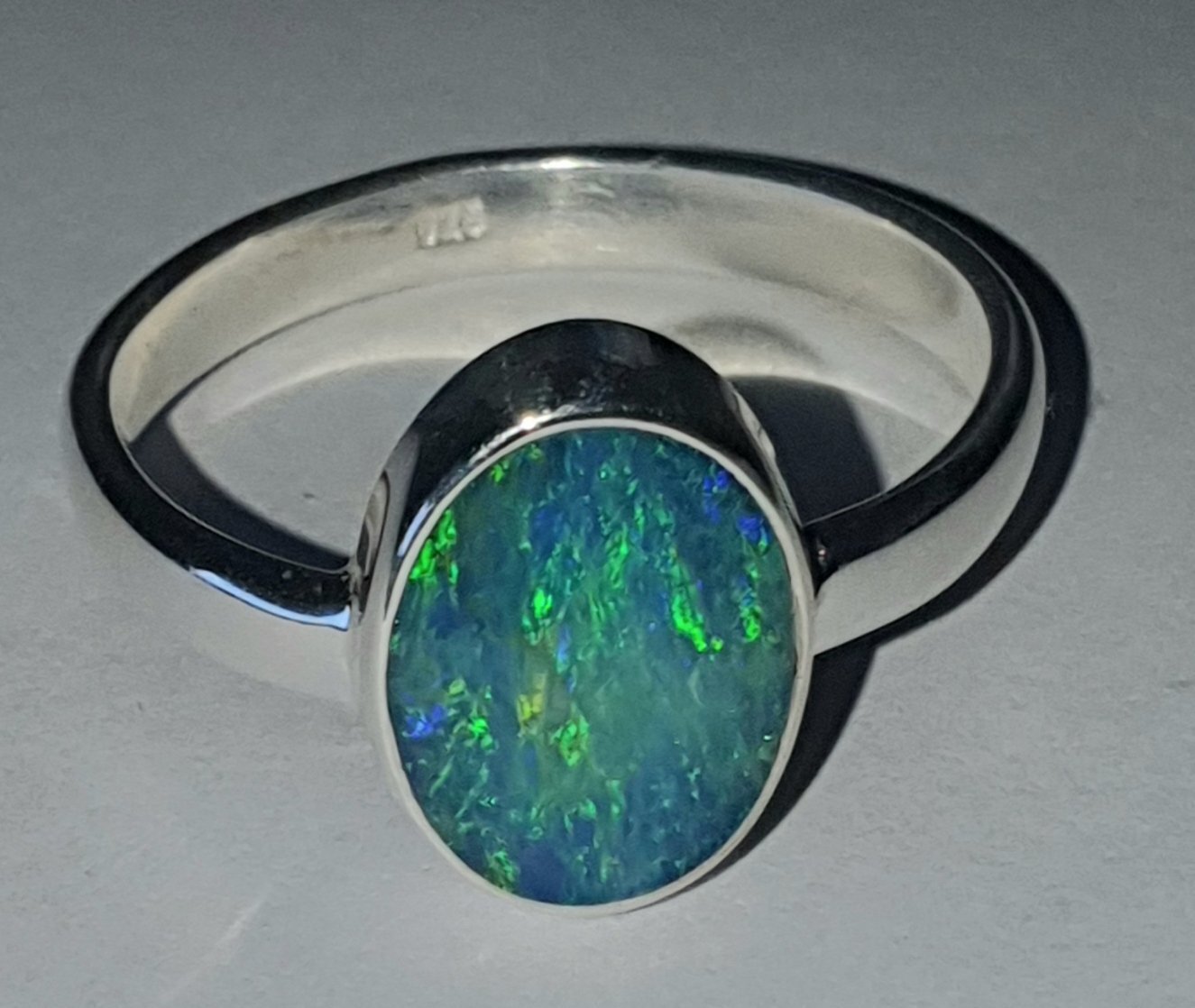 R21 a Sterling Silver Set Dark Opal Doublet Ring. 8 X 11 mm Across Face With Green & Blue Flash