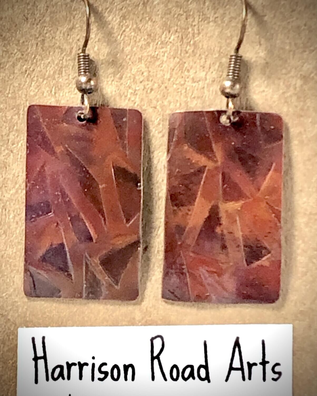 Flame painted copper, with stamped / rolled pattern. Steel ear wires