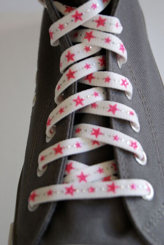 White shoelaces and neon pink stars