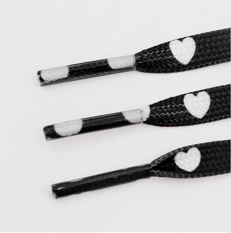 Fancy red flat shoelaces with white hearts