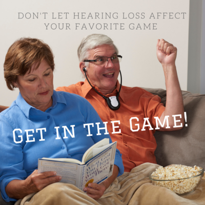 Man watching TV with Personal Sound Amplifier while wife reads book.
